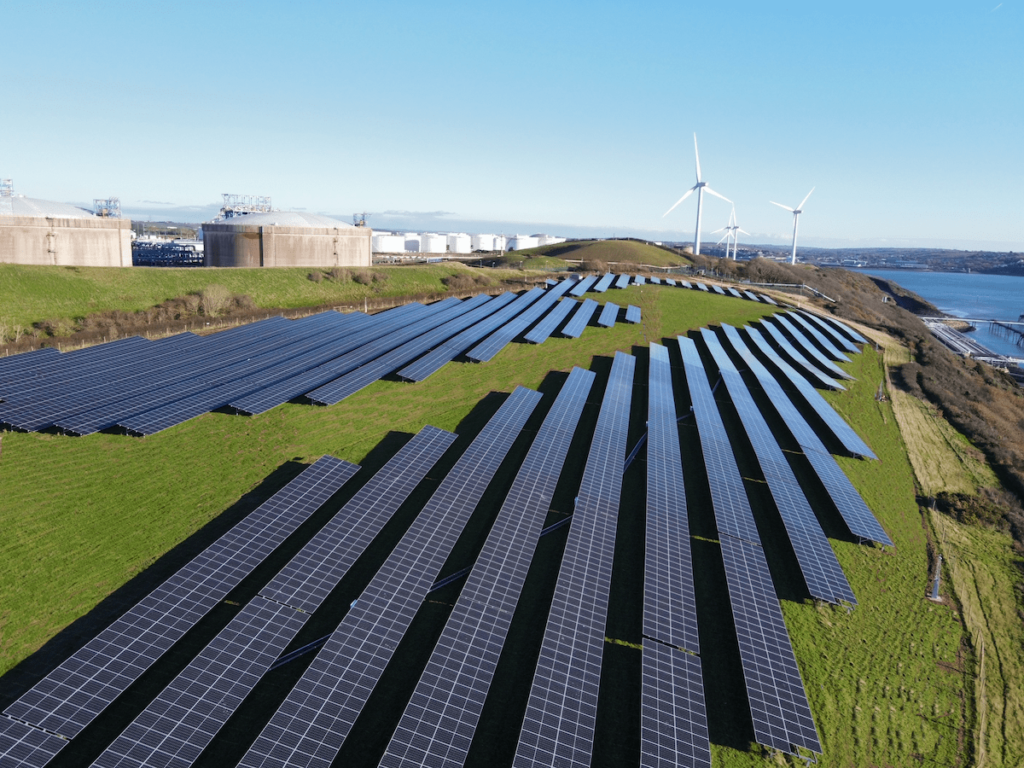 Solar Panels on the coast with wind turbine