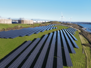 Solar Panels on the coast with wind turbine